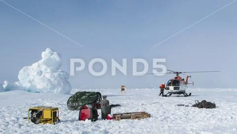 Helicopter assisted evacuation of a polar research camp Stock Photos