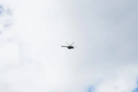 Helicopter on a background of blue sky with clouds Stock Photos