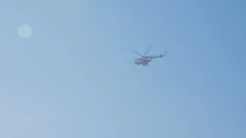 Helicopter on a background of blue sky Видео 147686424