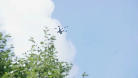 Helicopter on blue sky and trees background. Military equipment. 库存影片 143994607