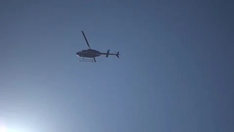Helicopter at blue sky with light rays. Slow motion fast shutter speed Stock Footage 100174747