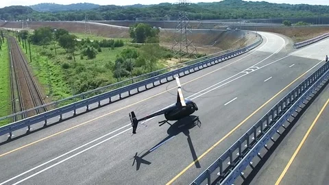 A helicopter boarded a road Stock Footage 141437944