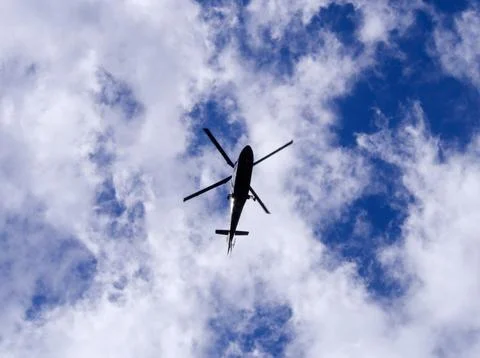 Helicopter bottom in cloudy sky Stock Photos