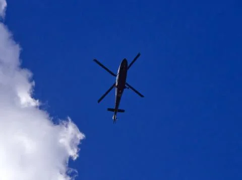Helicopter bottom in cloudy sky Foto stock