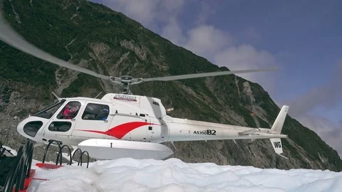 The helicopter carries visitors through Fox glaciers, New Zealand Stock Footage 79426088