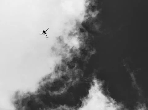 Helicopter with clouds Stock Photos