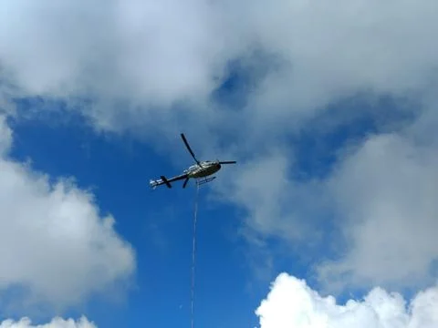Helicopter in the clouds Stock Photos