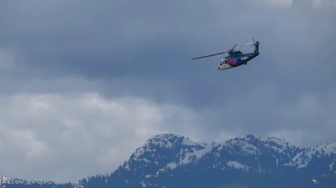 Helicopter In Cloudy Sky Near Mountains Stock Footage