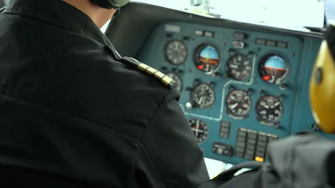 Helicopter commander in cockpit. Shoulder straps. View from back inside cabin Stock Footage 209589955