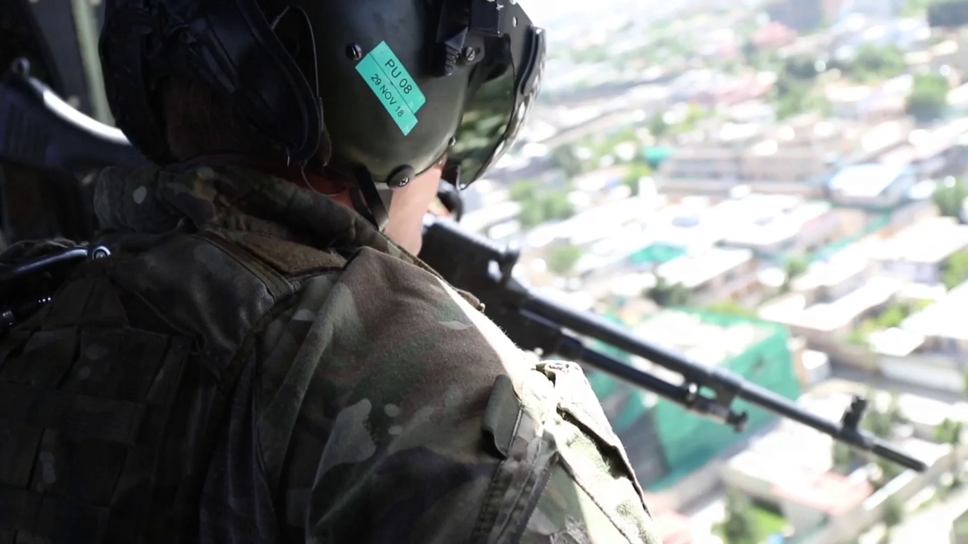 Helicopter Door Gunner Looking Out Over Streets Of Kabul Clip