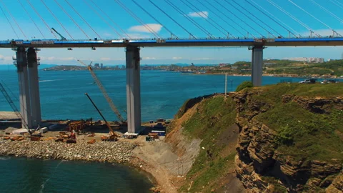 Helicopter ( drone, quadcopter ) flies next to the huge pillars of the bridge Stock Footage 92201818