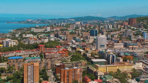 Helicopter ( drone, quadcopter ) flies over the city, the sea, houses  Stock Footage 92200901