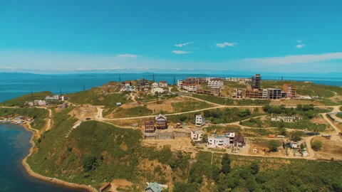 Helicopter ( drone, quadcopter ) flies over the city, the sea, houses  Stock Footage 92201057