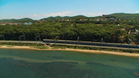 Helicopter ( drone, quadcopter ) flies over a settlement and a railway Stock Footage 92201167