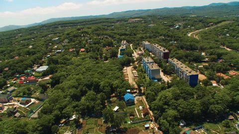 Helicopter ( drone, quadcopter ) flies over a settlement, trees, a railroad Stock Footage 92201449