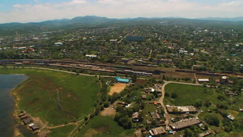 Helicopter ( drone, quadcopter ) flies over the settlement, the railway Stock Footage 92201478