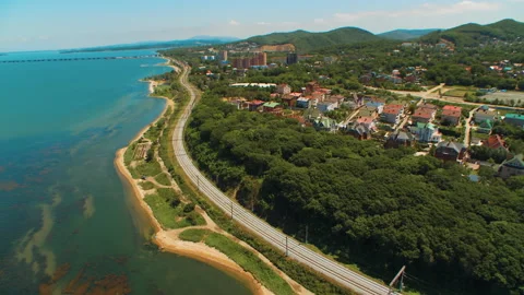 Helicopter ( drone, quadcopter ) flies over the settlement, the sea, the railway Stock Footage 92201580