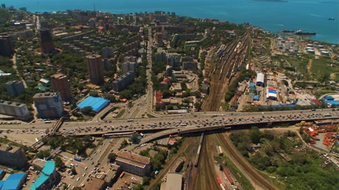 Helicopter ( drone, quadcopter ) flies over the city near the sea, houses, road Stock Footage 92201686