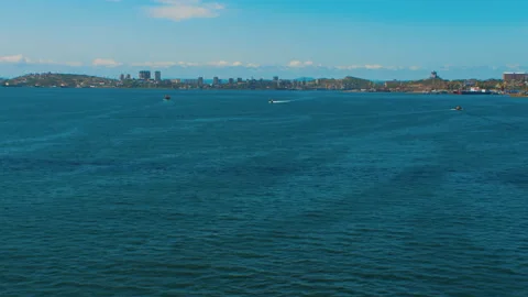 Helicopter ( drone, quadcopter ) flies over blue sea surface near a coastal city Stock Footage 92201721