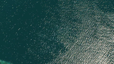 Helicopter ( drone, quadcopter ) flies over blue, sparkling in the rays of sea Stock Footage 92201783