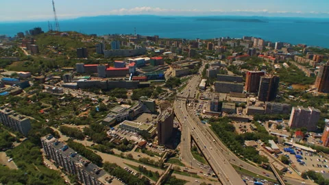 Helicopter ( drone, quadcopter ) flies over the city near the sea, houses, road Stock Footage 92201808