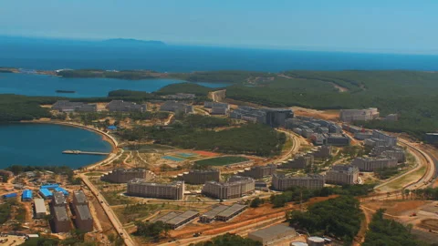 Helicopter ( drone, quadcopter ) flies over the city, the sea, houses  Stock Footage 92201902