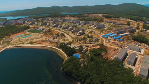 Helicopter ( drone, quadcopter ) flies over the city, the sea, houses  Stock Footage 92202040