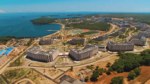 Helicopter ( drone, quadcopter ) flies over the city, the sea, houses  Stock Footage 92208686