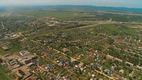 Helicopter ( drone, quadcopter ) flies over a settlement, trees and fields Stock Footage 92208927