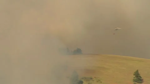 Helicopter drops water on fire Stock Footage 21534593