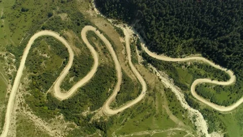 Helicopter epic alpine dirt winding road serpentine path to Caucasus mountains  Stock Footage 150922908