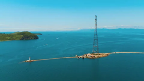 Helicopter flies above the beacon and the tower of the repeater Stock Footage 92201047