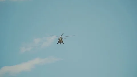 Helicopter flies in the blue sky 動画素材 112830852