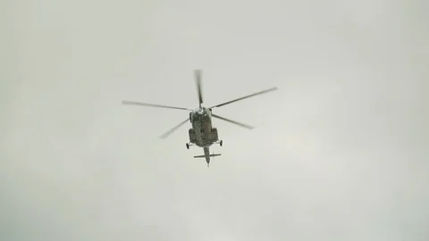 Helicopter flies in the blue sky 库存影片 112830865
