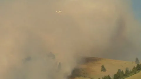 Helicopter flies by clouds of smoke Stock Footage 21534610