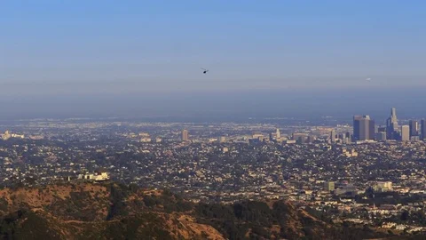 Helicopter Flies by the Griffith Observatory and Downtown Los Angeles View Stock Footage 76547525