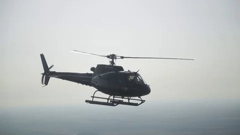 The helicopter flies high in the sky Stock Footage 77146497