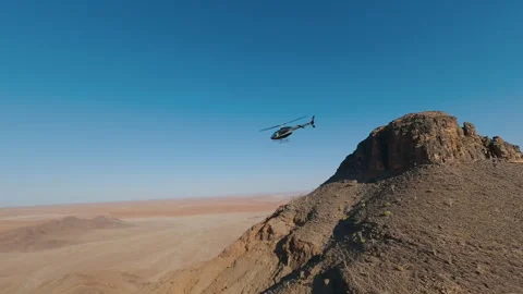 Helicopter Flies Over the Desert Stock Footage 295027744