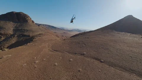 Helicopter Flies Over the Desert Stock Footage 295028599