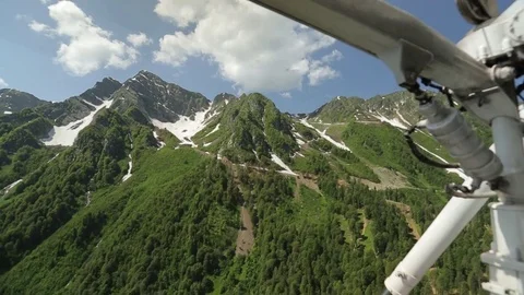 Helicopter flies over the mountains Stock Footage 73104904