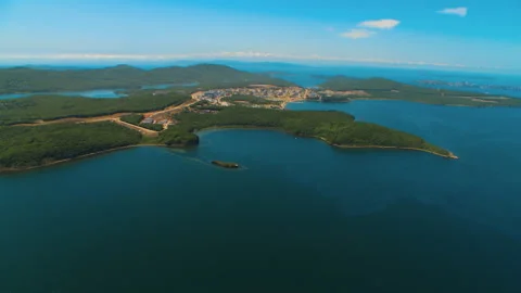 Helicopter flies over the water area of the sea and over the island Stock Footage 92201863