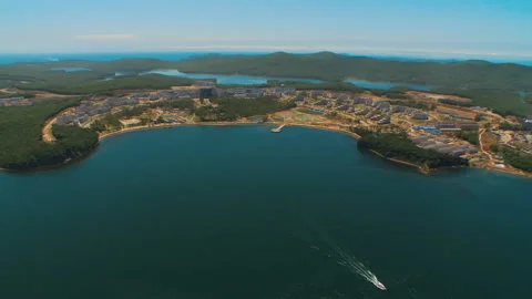 Helicopter flies over the water area of the sea and over the island Stock Footage 92201923