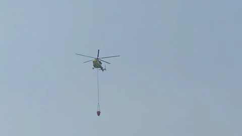Helicopter flies to put out the fire Stock Footage 247111844