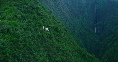 Helicopter flies in search of the most epic waterfalls Stock Footage 102677530