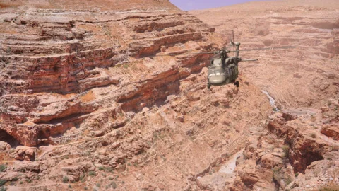 The helicopter flies through the gorge. Video stock 143320090