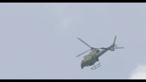 Helicopter flies through sky with clouds Stock Footage 57218649