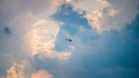 Helicopter in flight into the clouds Stock Photos