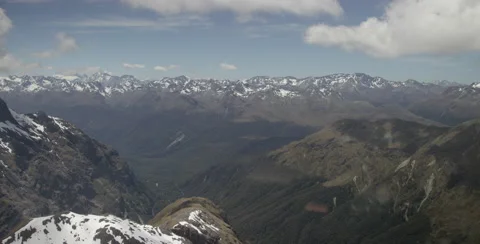 Helicopter flight over mountains. Some snow covered. 6K Wide but hand held Stock Footage 64452616