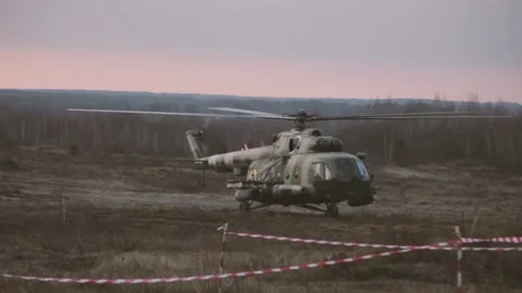 Helicopter in flight at sunset above war field Stock Footage 119152441