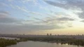 The helicopter flights over the river in megapolis landscape 4k or 4k+ Resolution